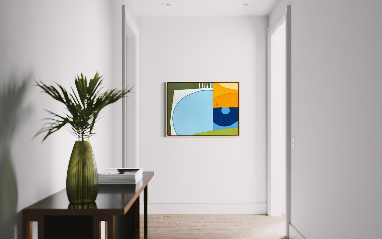 Off the Wall tropical abstract wall art by Kristen Guest Studio in blue, green, teal and yellow—framed geometric circle composition on white wall.