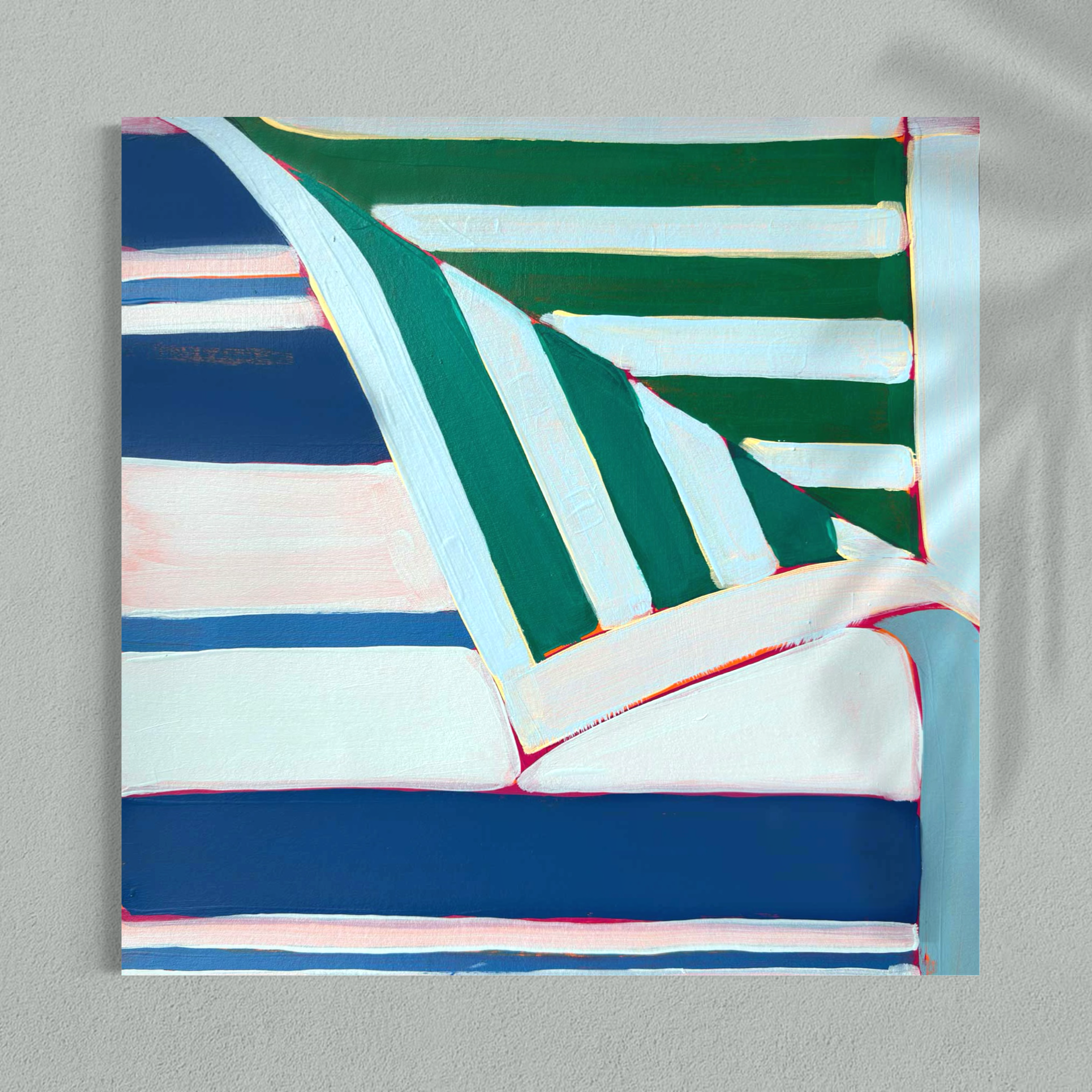 Abstract painting shows green and white diagonal panels with blue and red trim over a striped background, set against a pale wall.