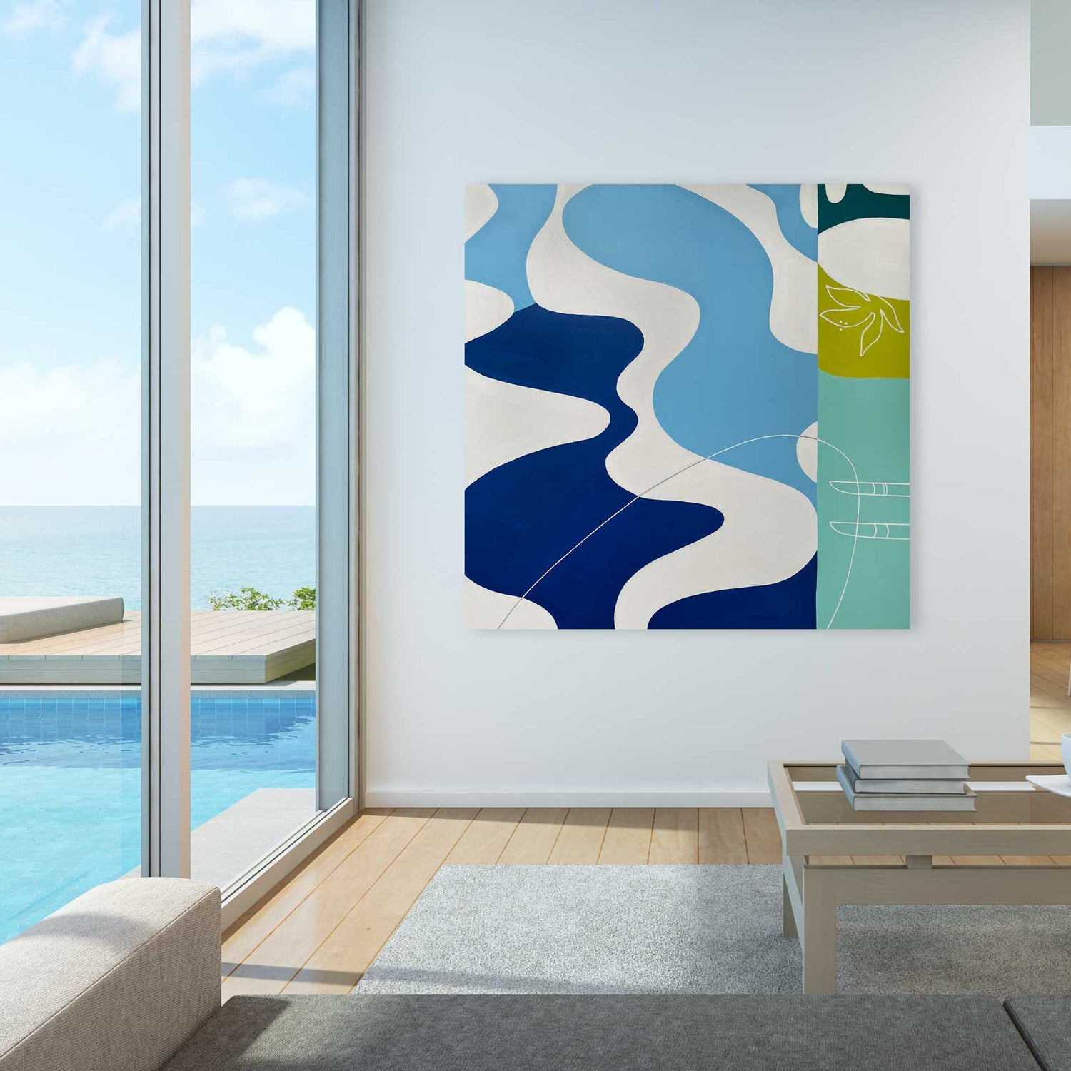 Modern living room shows a wall-mounted abstract artwork in blue and green beside an open sliding door with ocean view and pool.